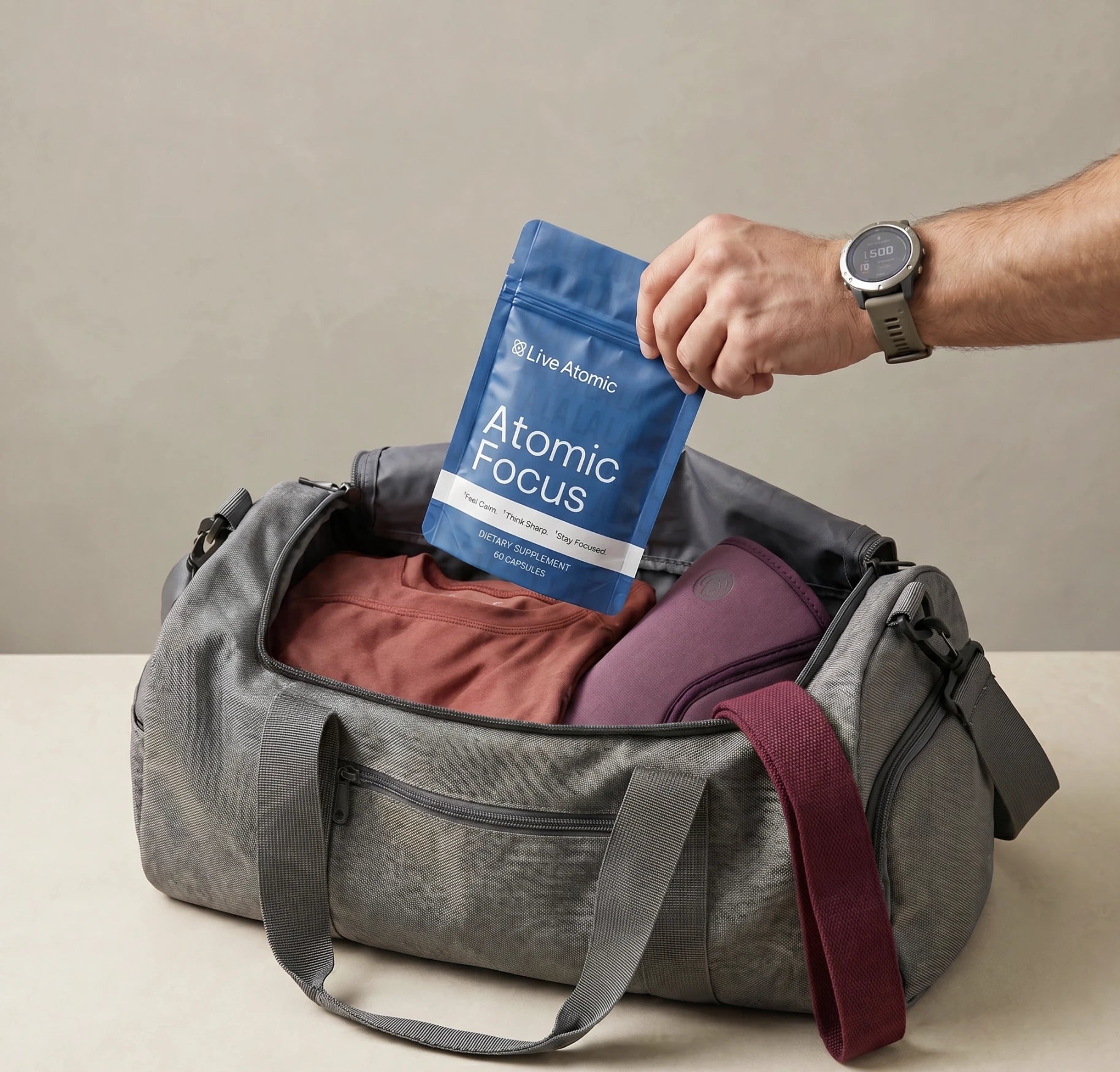 Atomic Focus pouch being placed in a duffel bag