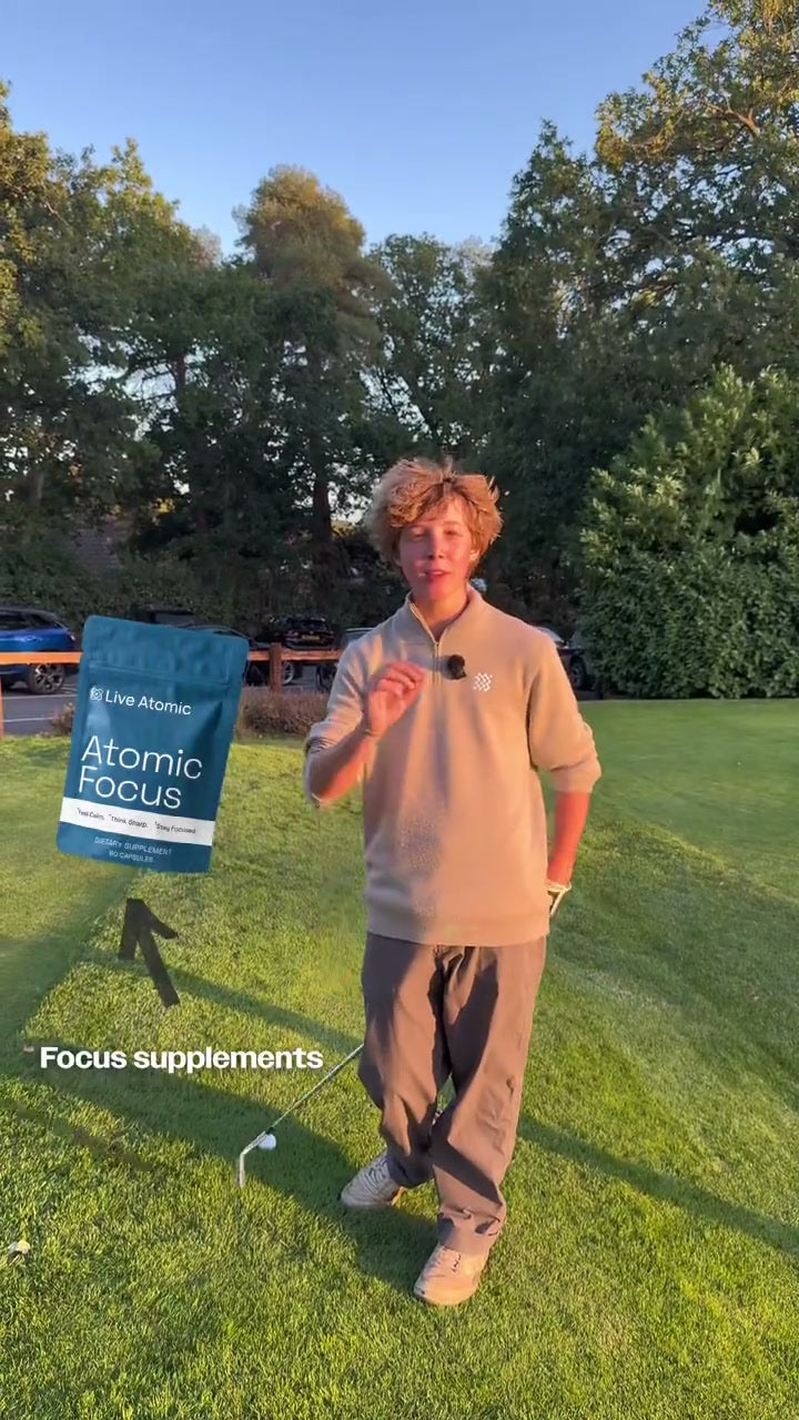 Golfer holding Atomic Focus during an outdoor practice session